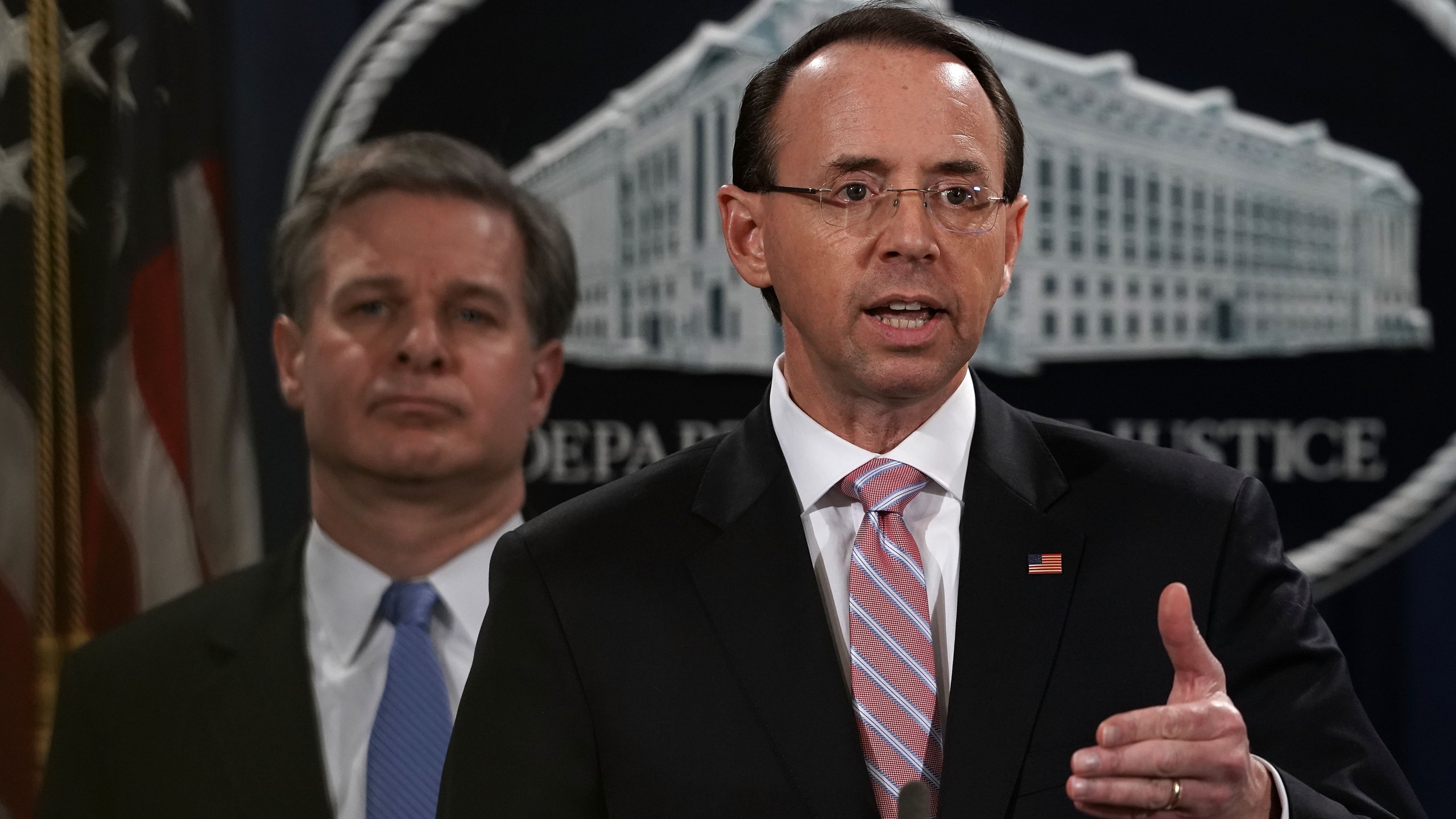 U.S. Deputy Attorney General Rod Rosenstein (right) speaks as FBI Director Christopher Wray listens during a news conference to announce a China-related national security law enforcement action on Dec. 20, 2018. (Credit: Alex Wong/Getty Images)