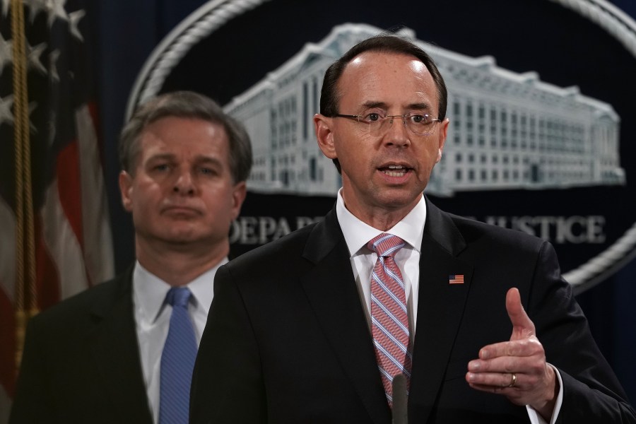 U.S. Deputy Attorney General Rod Rosenstein (right) speaks as FBI Director Christopher Wray listens during a news conference to announce a China-related national security law enforcement action on Dec. 20, 2018. (Credit: Alex Wong/Getty Images)