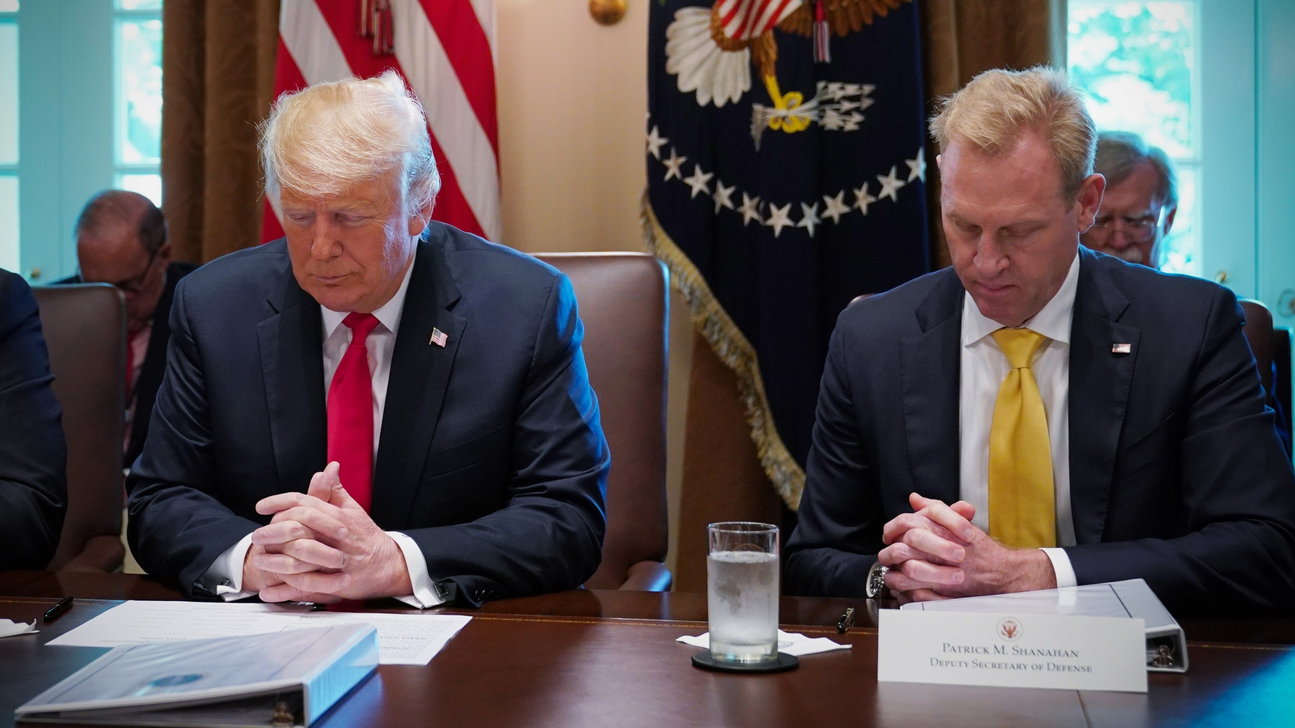 Donald Trump and Patrick Shanahan bow their heads in prayer before the start of a Cabinet meeting in the Cabinet Room of the White House on Aug. 16, 2018. (Credit: MANDEL NGAN/AFP/Getty Images)