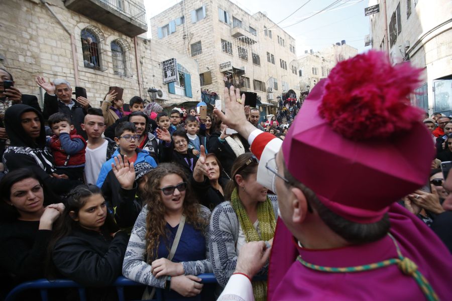 Latin Patriarch of Jerusalem Pierbattista Pizzaballa greets a crowd as he arrives in the West Bank city of Bethlehem, on Dec. 24, 2018. (Credit: HAZEM BADER/AFP/Getty Images)