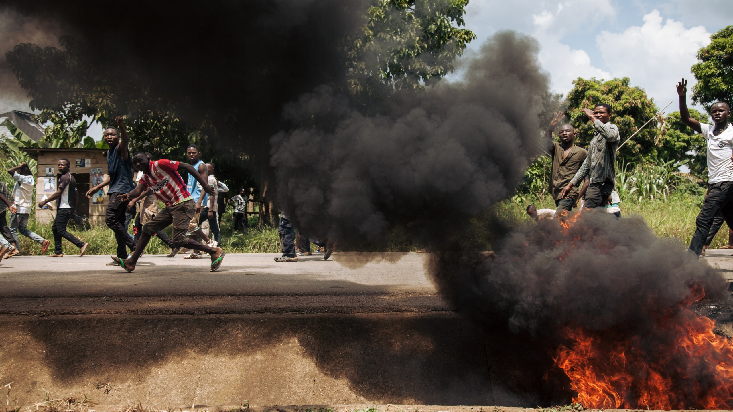 Protesters walk near the electoral commission in Beni during a demonstration against the postponement of elections in the territory of the Beni and the city of Butembo on Dec. 27, 2018. (Credit: ALEXIS HUGUET/AFP/Getty Images)