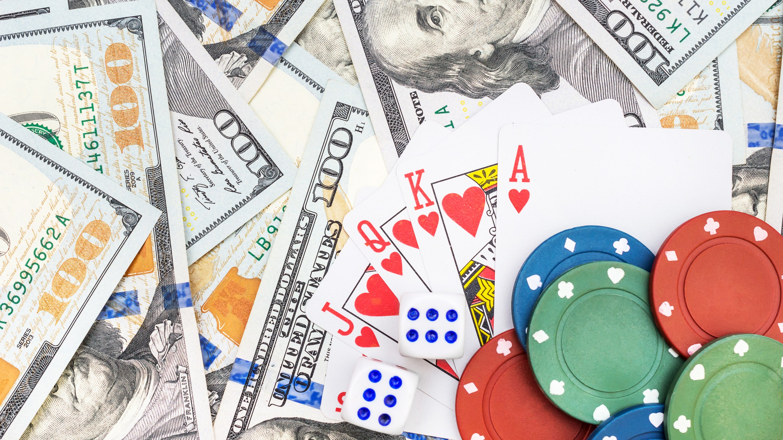 A file photo of dice, poker chips, playing cards and cash. (Credit: iStock / Getty Images Plus)