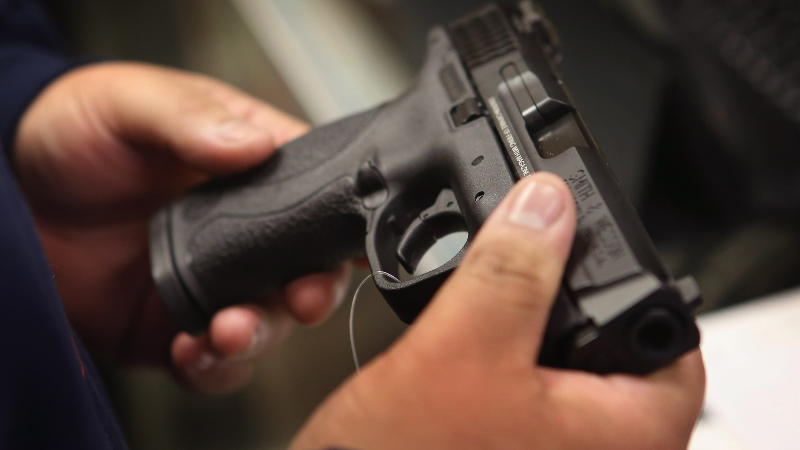 A person holds a pistol in this file photo. (Credit: Scott Olson/Getty Images)