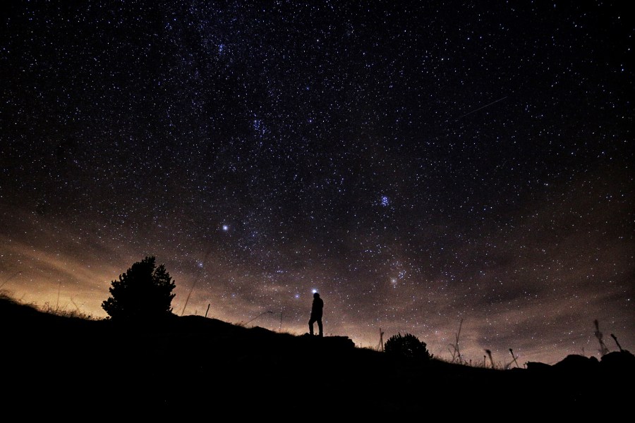 A photographer prepares to take pictures of the annual Geminid meteor shower on the Elva Hill, in Maira Valley, near Cuneo, northern Italy on December 12, 2015. (Credit: MARCO BERTORELLO/AFP/Getty Images)