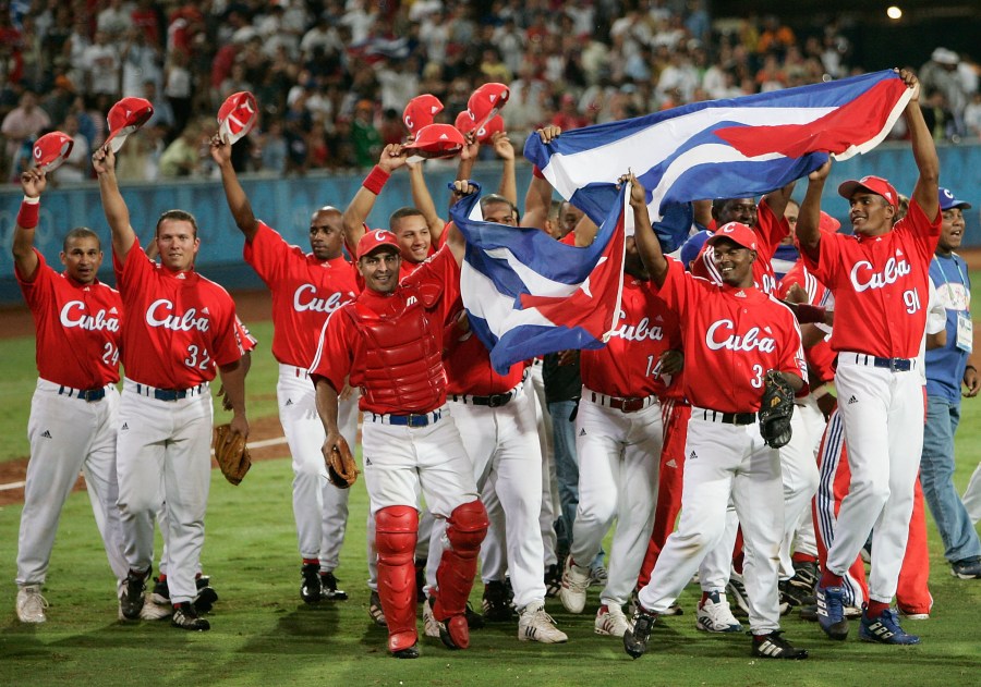 Cuba celebrates their victory over Australia in the gold medal baseball game on August 25, 2004 during the Athens 2004 Summer Olympic Games at the Baseball Centre in the Helliniko Olympic Complex in Athens, Greece. (Credit: Donald Miralle/Getty Images)