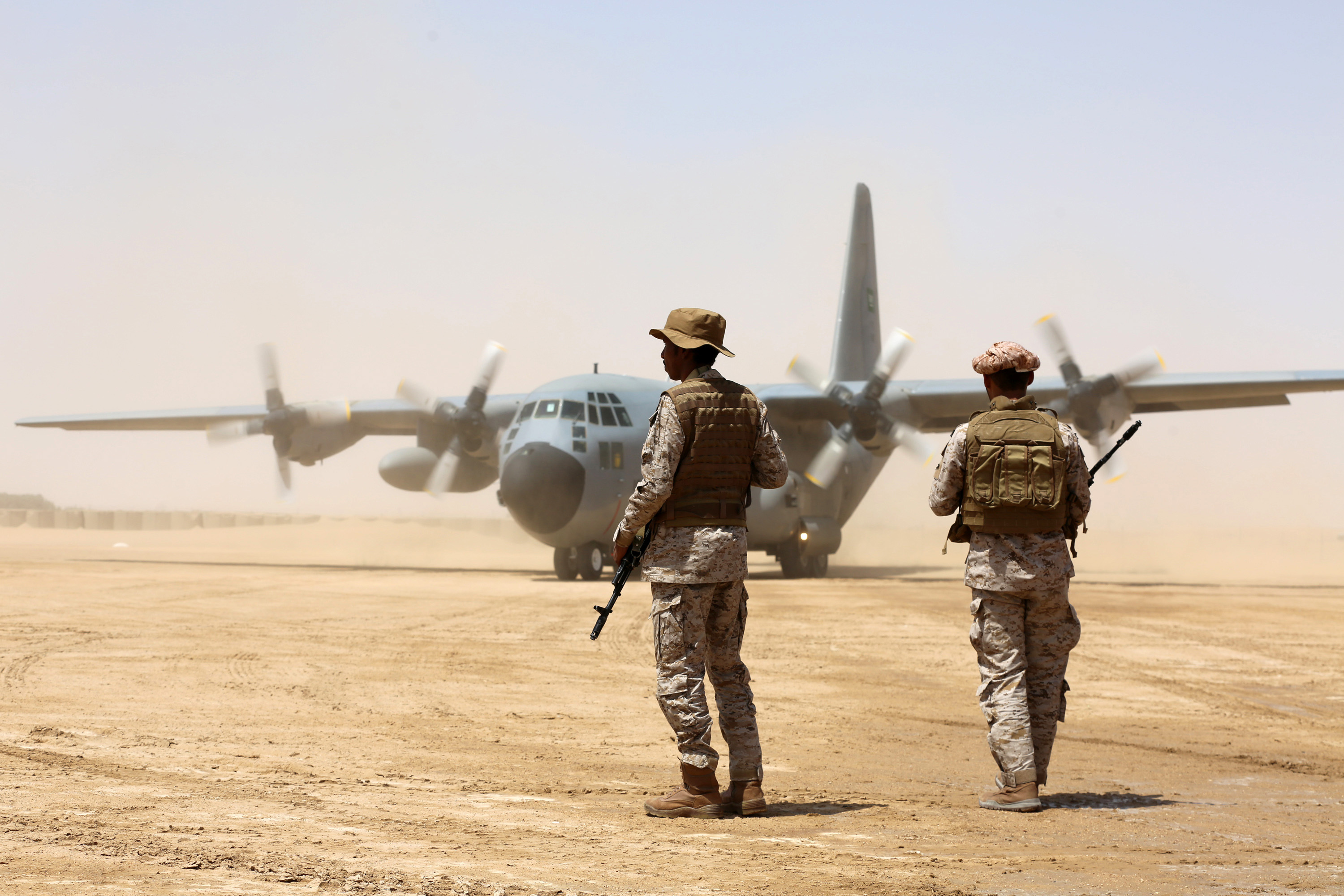 Saudi soldiers stand guard before aid supplies are unloaded from a Saudi air force cargo plane at an airfield in Yemen's central province of Marib, on March 12, 2018.( Credit: Abdullah Al-Qadry/AFP/Getty Images)