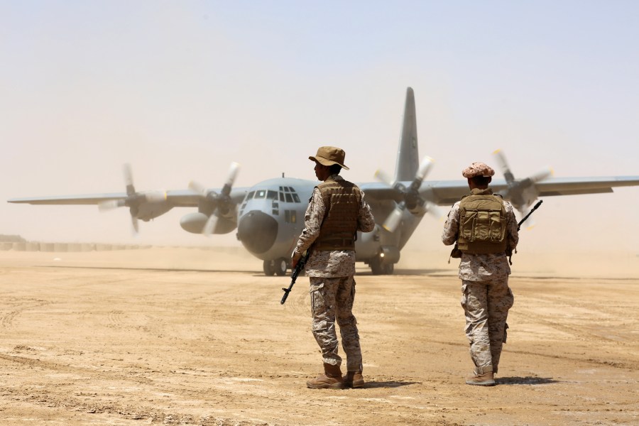 Saudi soldiers stand guard before aid supplies are unloaded from a Saudi air force cargo plane at an airfield in Yemen's central province of Marib, on March 12, 2018.( Credit: Abdullah Al-Qadry/AFP/Getty Images)