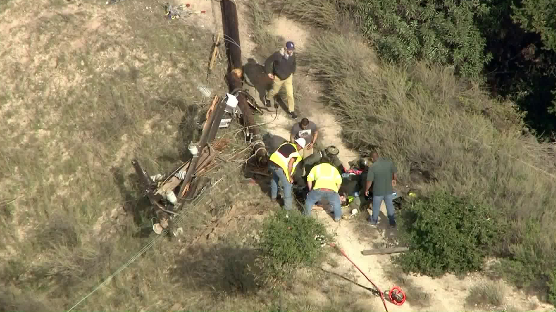 A utility pole fell in Lopez Canyon on Dec. 17, 2018, injuring two workers, authorities say. (Credit: KTLA)