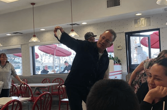 Instagram use @bookcauldron13 posted this image of Tom Hanks taking a selfie with fans on Dec. 21, 2018.