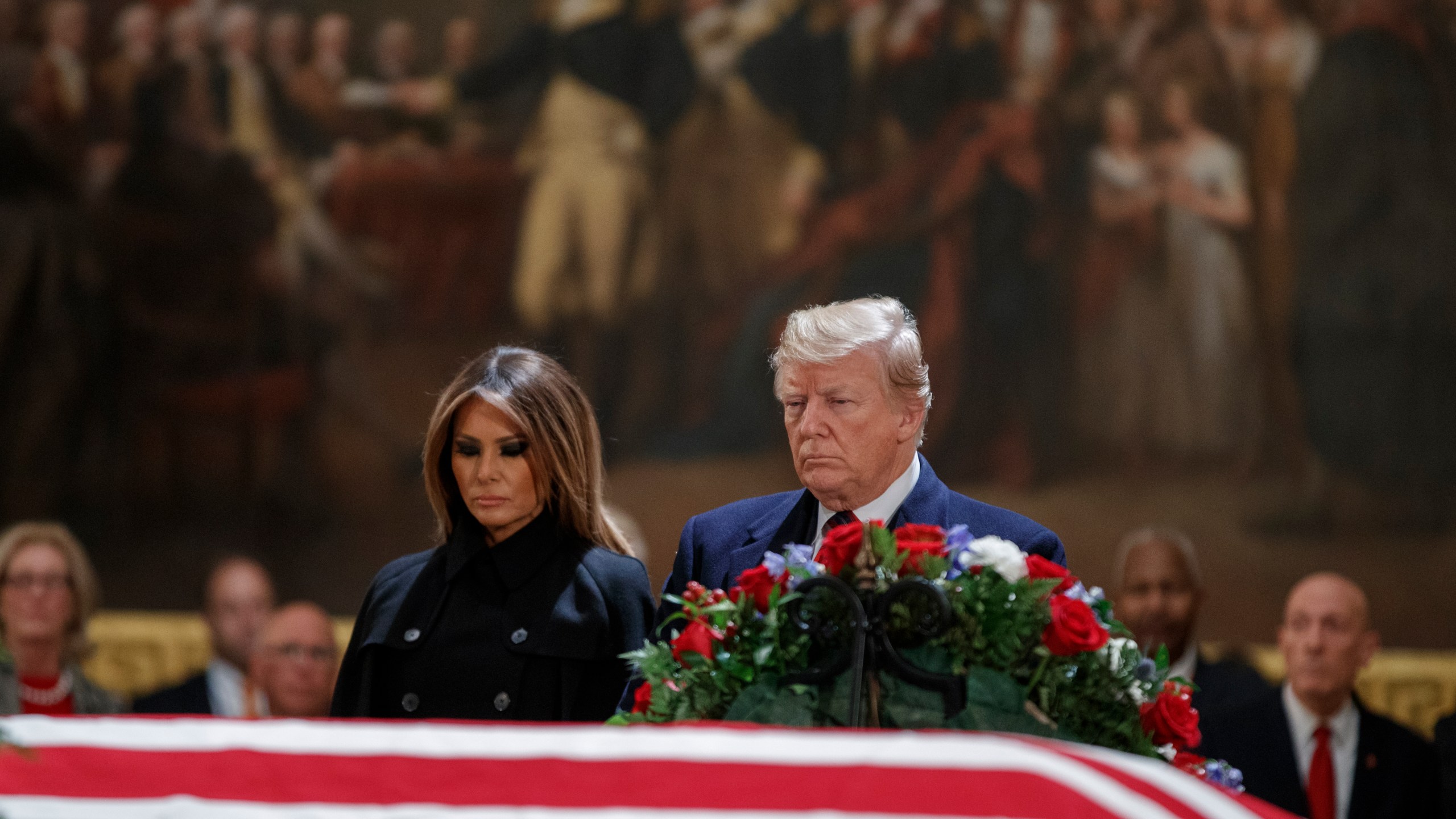 Donald Trump and first lady Melania Trump pay their respects to former President George H.W. Bush as he lies in state in the U.S. Capitol Rotunda on Dec. 3, 2018. (Credit: Shawn Thew-Pool/Getty Images)