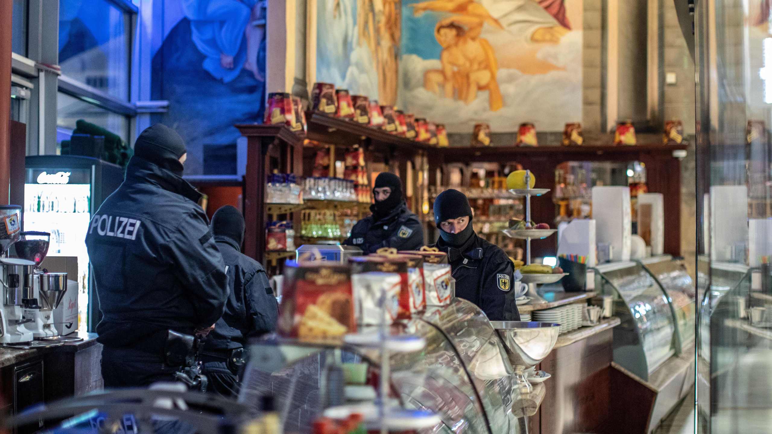 Policemen raid an ice cafe in Duisburg, western Germany, on December 5, 2018. (Credit: CHRISTOPH REICHWEIN/AFP/Getty Images)