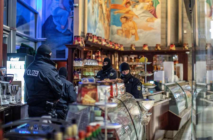 Policemen raid an ice cafe in Duisburg, western Germany, on December 5, 2018. (Credit: CHRISTOPH REICHWEIN/AFP/Getty Images)