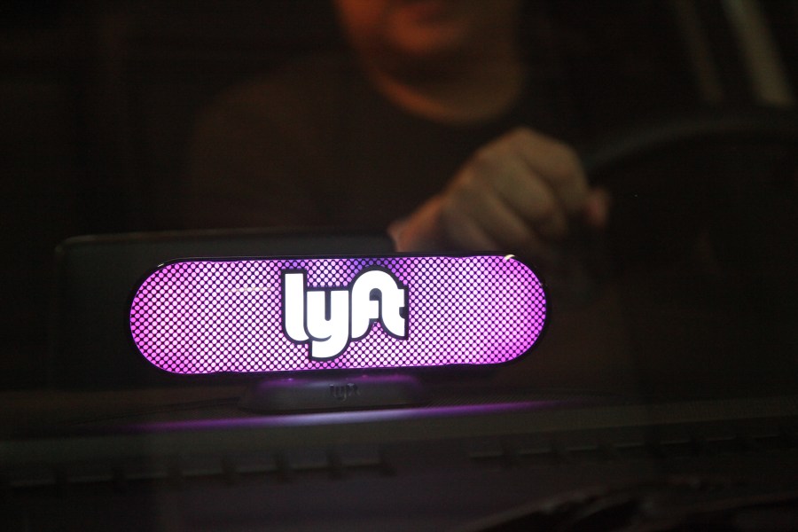 A Lyft logo glows on a driver's dashboard in San Francisco on Jan. 31, 2017. (Credit: Kelly Sullivan / Getty Images)