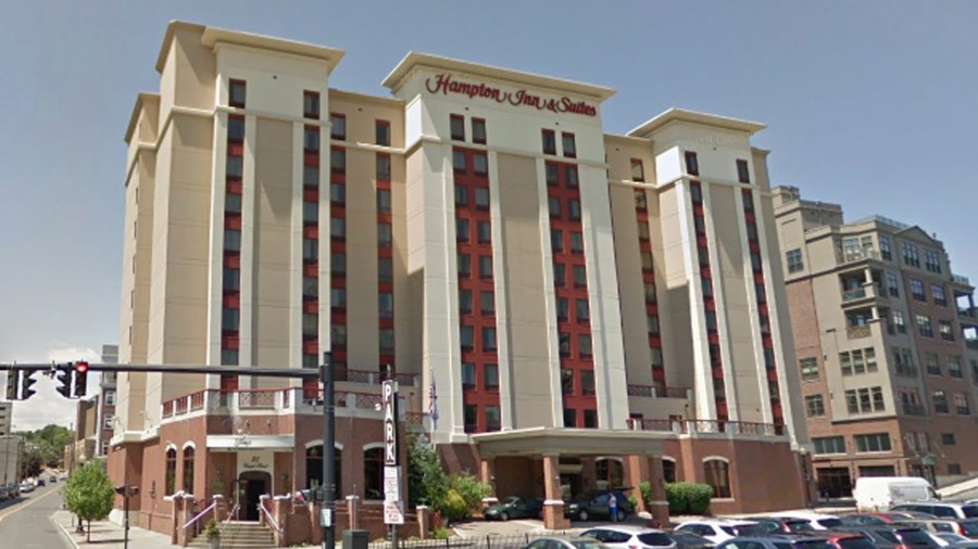 A Google Maps street view image shows the Hampton Inn and Suites in downtown Albany, New York.