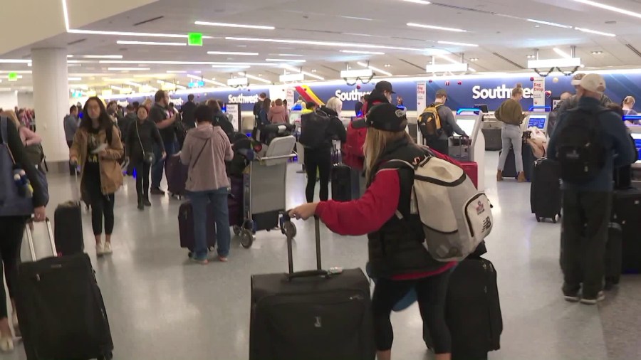 Children and surviving spouses of fallen U.S. military heroes gather at the Los Angeles International Airport before heading to Disney World on Dec. 8, 2018. (Credit: KTLA)