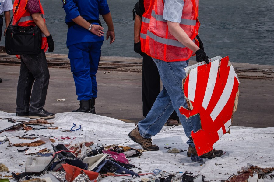 National Transportation Safety Board (NTSB) and Boeing official check debris from Lion Air flight JT 610 at the Tanjung Priok port on November 1, 2018 in Jakarta, Indonesia. (Credit: Ulet Ifansasti/Getty Images)