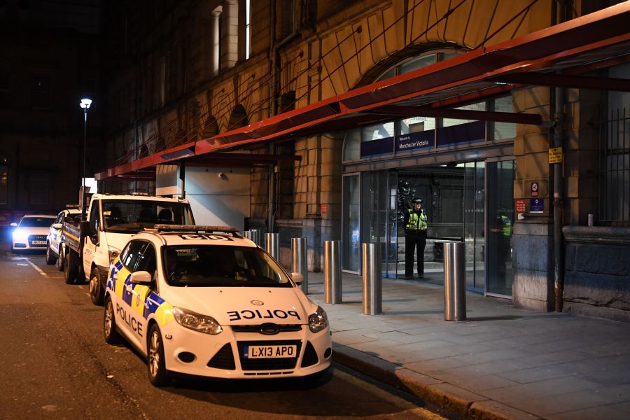 Police officers stand near a cordon at Manchester Victoria Station, in Manchester on January 1, 2019, following a stabbing on December 31, 2018. (Credit: PAUL ELLIS/AFP/Getty Images)