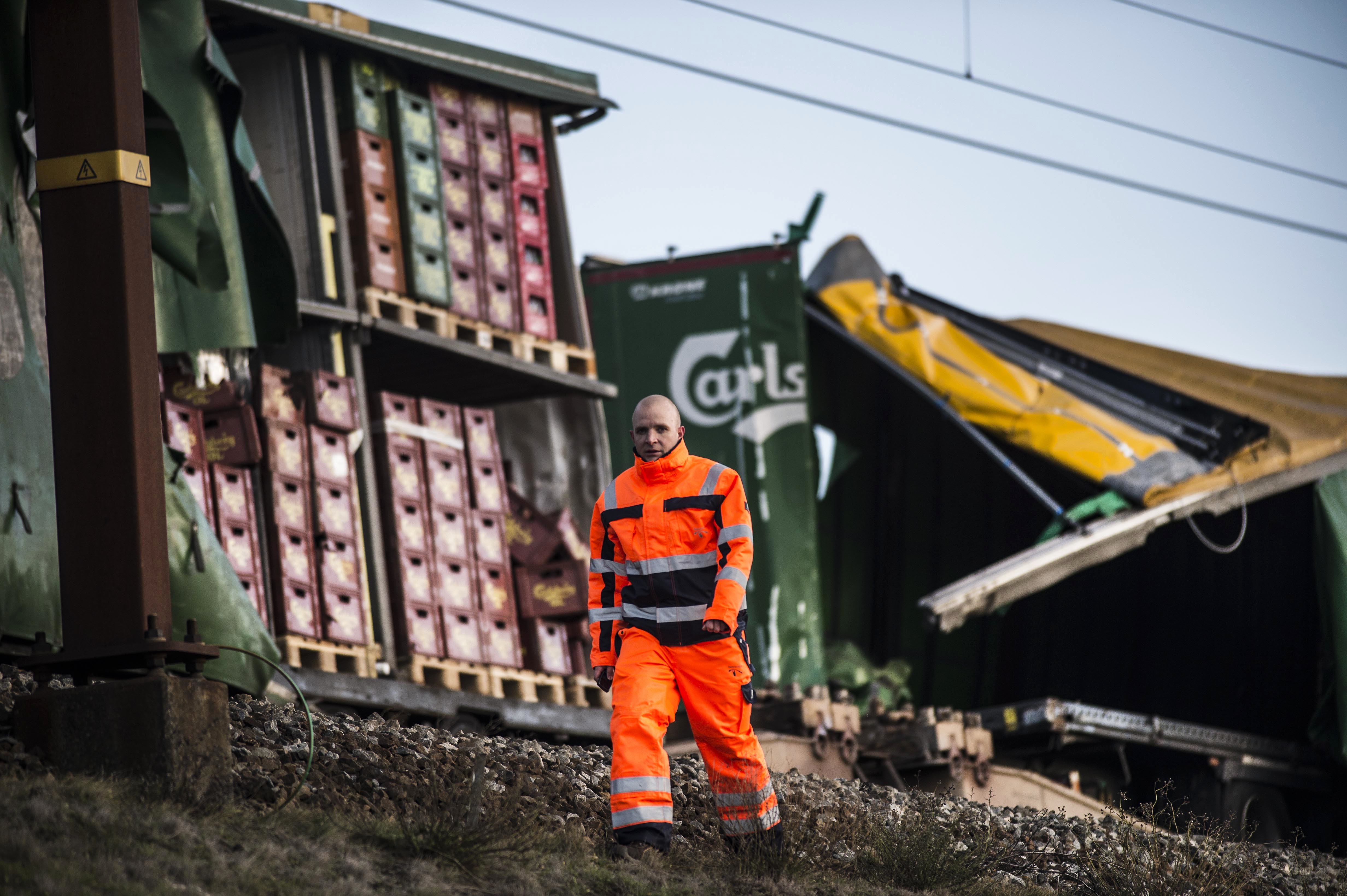 A staff member walks past damaged containers on a cargo train on the Great Belt Bridge after a railway accident on January 2, 2019 in Nyborg, Denmark. (Credit: TIM KILDEBORG JENSEN/AFP/Getty Images)