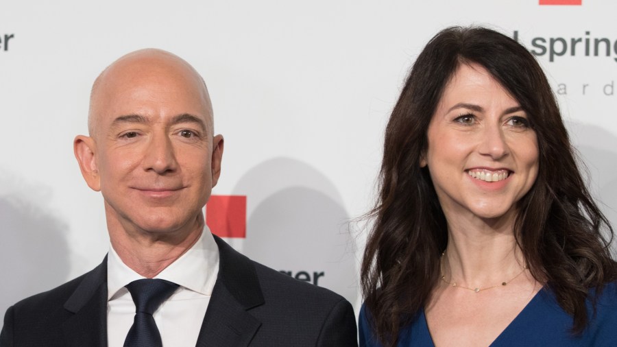 Amazon CEO Jeff Bezos and his wife MacKenzie Bezos poses as they arrive at the headquarters of publisher Axel-Springer in Berlin on April 24, 2018. (Credit: Jorg Carstensen/AFP/Getty Images)