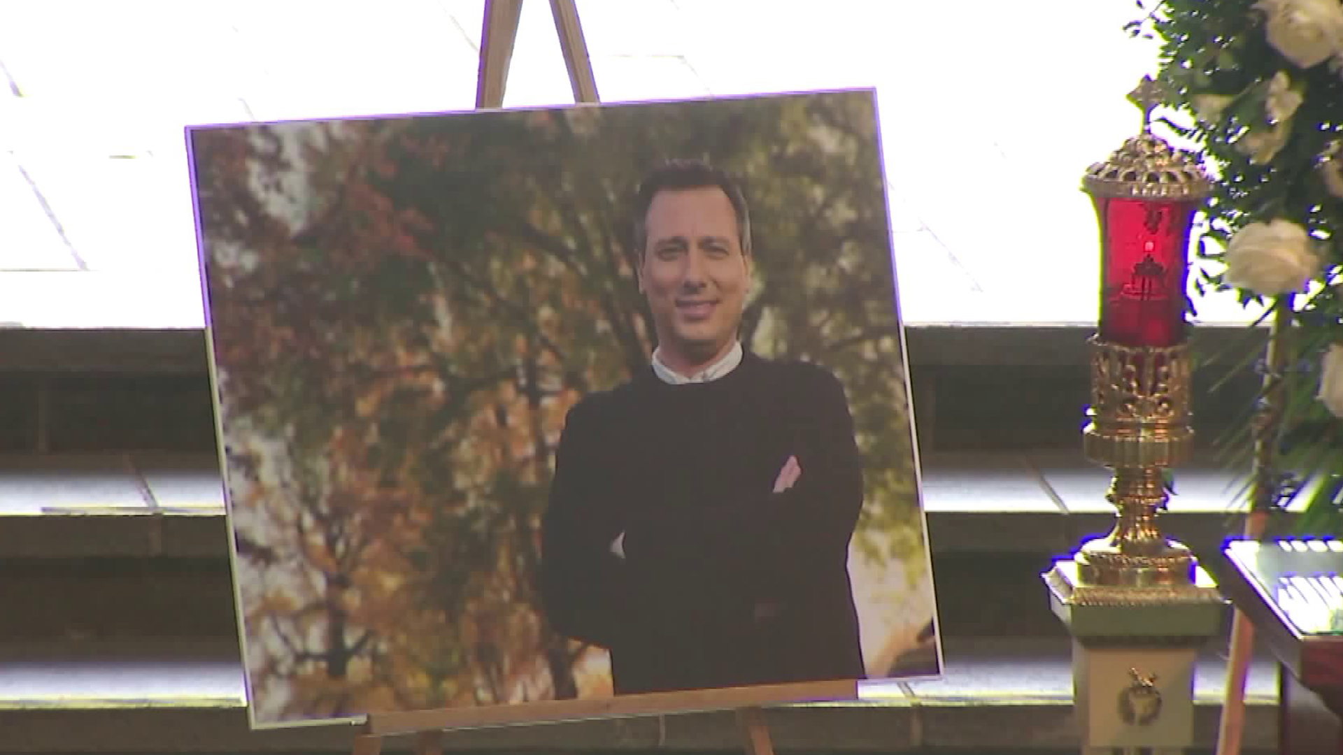 Beloved KTLA anchor and reporter Chris Burrous is pictured in a photo displayed at a memorial service held in his honor, on Jan. 11, 2019, in Whittier. He passed away on Dec. 27, 2018. (Credit: KTLA)