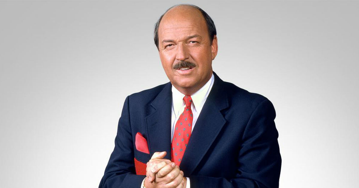 "Mean" Gene Okerlund is shown in an official WWE portrait.