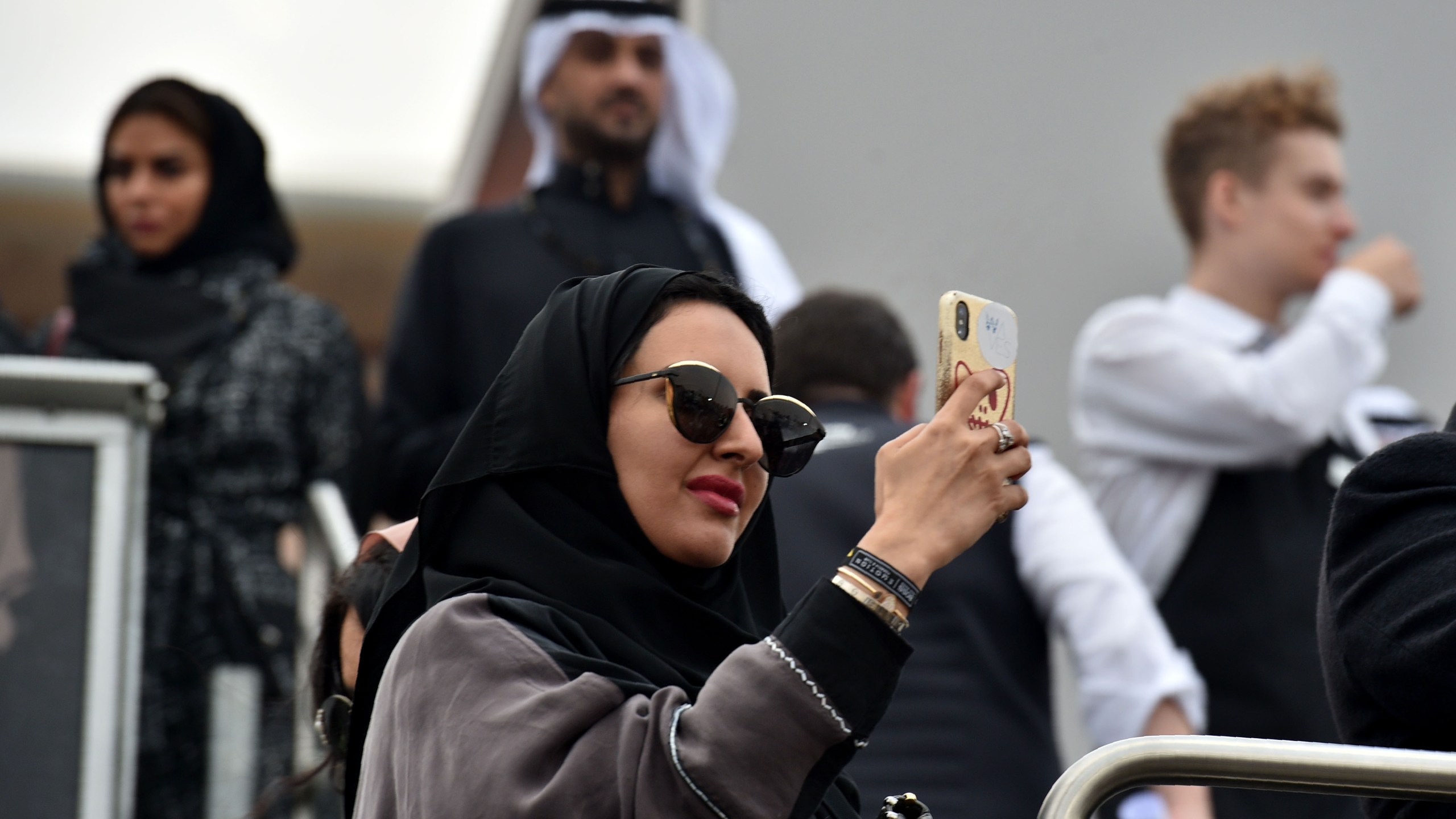 A Saudi woman takes photographs with her phone at the E-Prix Formula E Championship in Riyadh, on Dec. 15, 2018. (Credit: Fayez Nuerldine/AFP/Getty Images)