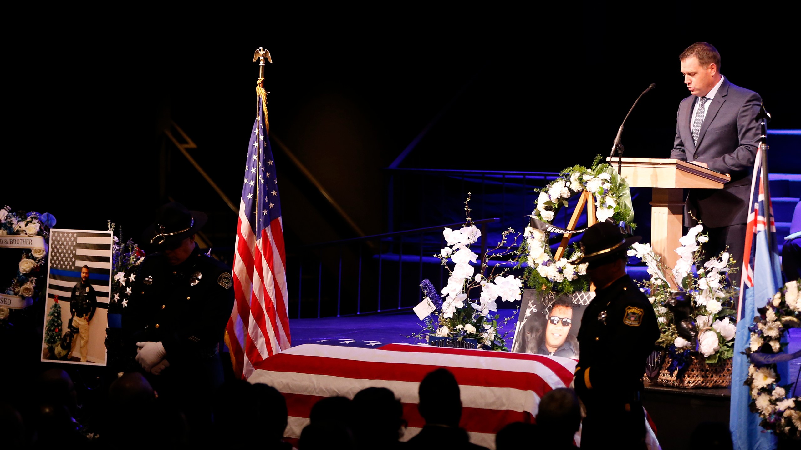 Officer Jeffrey Harmon of the Modesto Police Department speaks as the flag-draped casket of slain Newman police officer Ronil Singh is seen during a funeral service at CrossPoint Community Church on Jan. 5, 2019, in Modesto. (Credit: Stephen Lam/Getty Images)