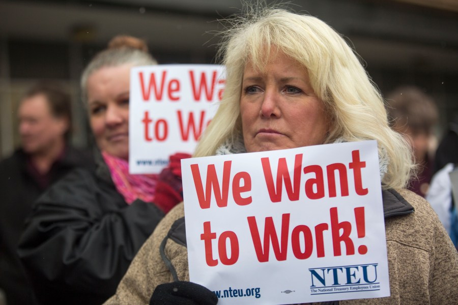 IRS employee Pam Crosbie and others hold signs protesting the government shutdown at the James V. Hansen Federal Building on Jan. 10, 2019, in Ogden, Utah. (credit: Natalie Behring/Getty Images)