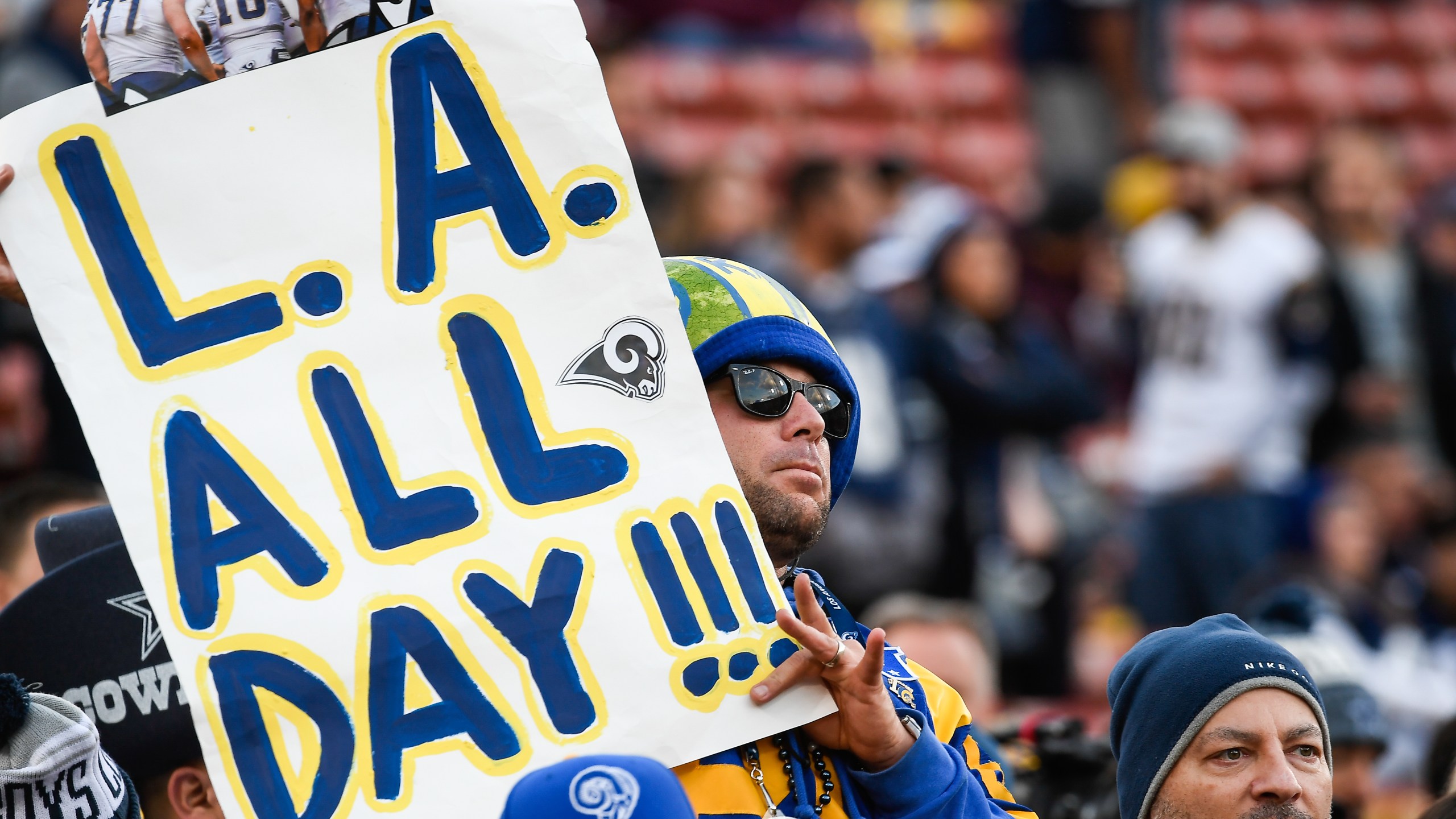 A Los Angeles Rams fan holds a sign ahead of the NFC Divisional Round playoff game against the Dallas Cowboys at Los Angeles Memorial Coliseum on Jan. 12, 2019. (Credit: Kevork Djansezian/Getty Images)