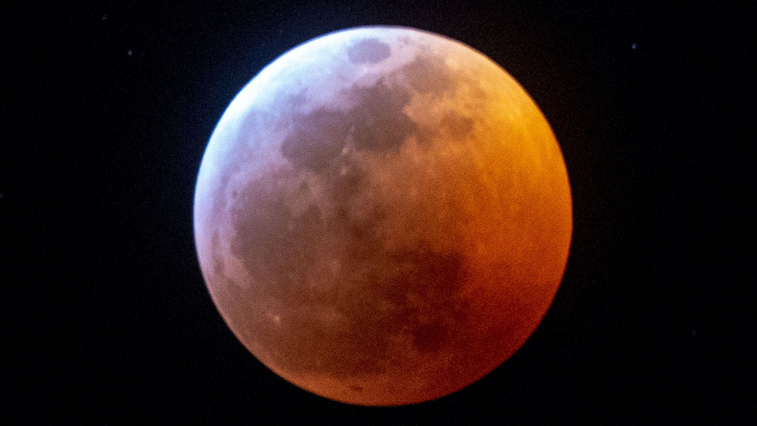 Earth's shadow almost totally obscures the view of the so-called Super Blood Wolf Moon during a total lunar eclipse, on Sunday January 20, 2019, in Miami. (GASTON DE CARDENAS/AFP/Getty Images)