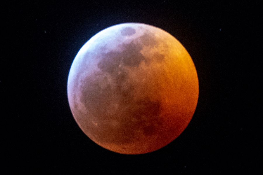 Earth's shadow almost totally obscures the view of the so-called Super Blood Wolf Moon during a total lunar eclipse, on Sunday January 20, 2019, in Miami. (GASTON DE CARDENAS/AFP/Getty Images)