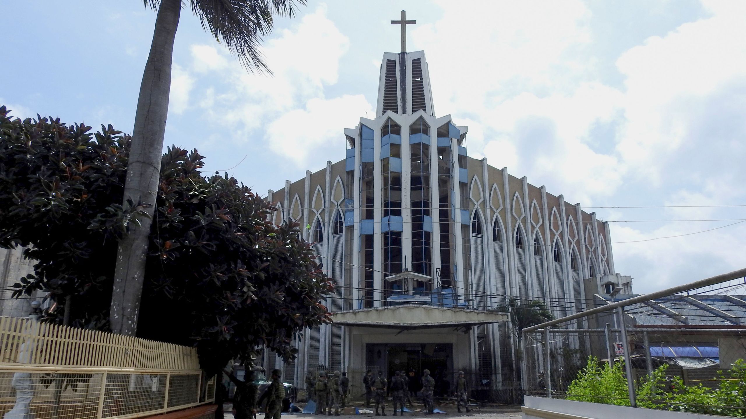 Policemen and soldiers are seen in front of a Catholic Church on Jan. 27, 2019, where the bombing took place in Jolo, Sulu province on the southern island of Mindanao.(Credit: Nickee Butlangan/AFP/Getty Images)