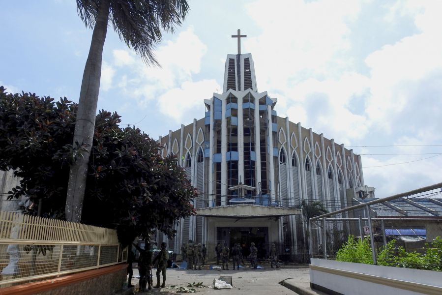 Policemen and soldiers are seen in front of a Catholic Church on Jan. 27, 2019, where the bombing took place in Jolo, Sulu province on the southern island of Mindanao.(Credit: Nickee Butlangan/AFP/Getty Images)