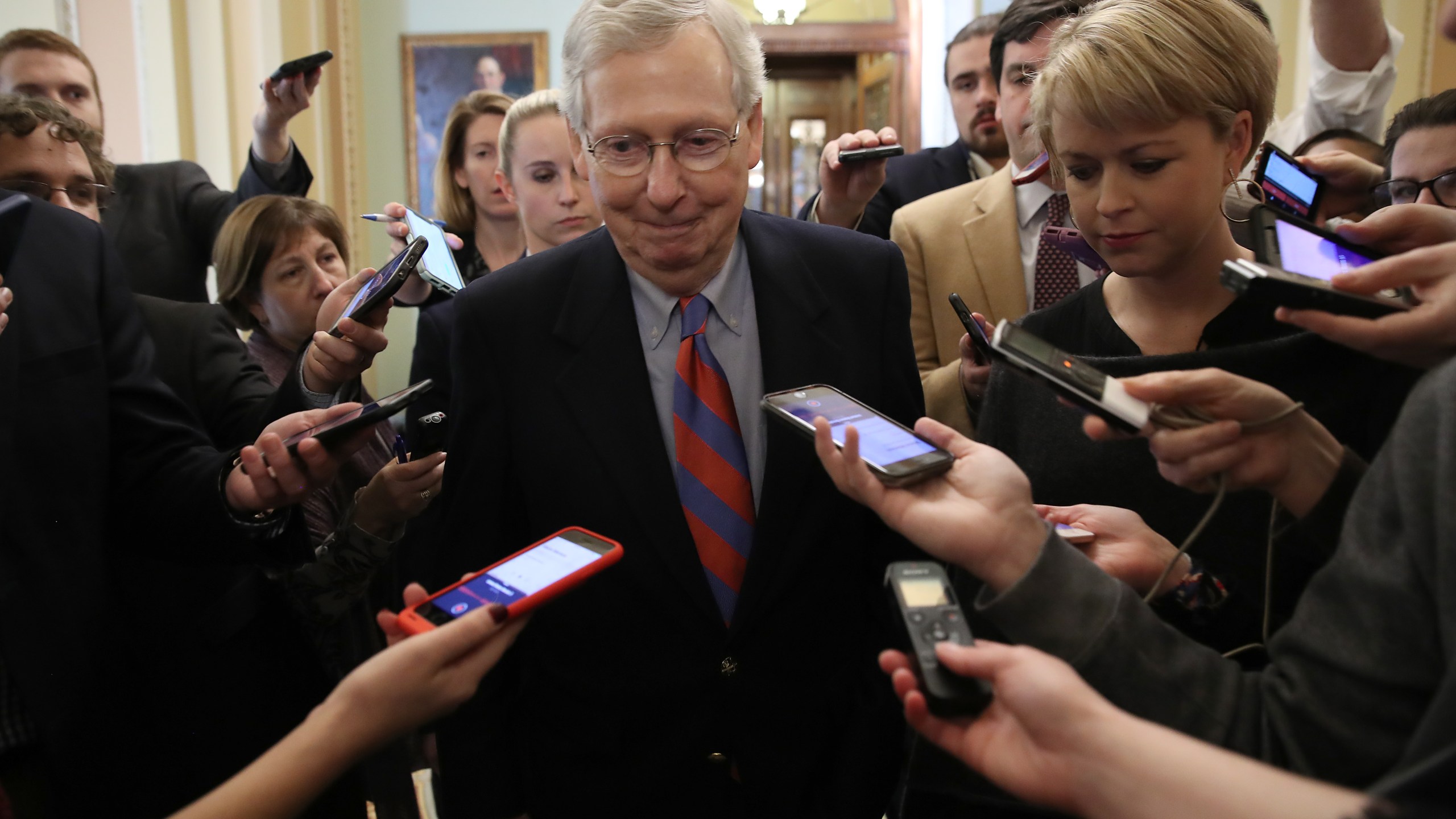 Senate Majority Leader Mitch McConnell (R-KY) smiles while talking with reporters following remarks on the Senate floor on Jan. 25, 2019. (Credit: Win McNamee/Getty Images)