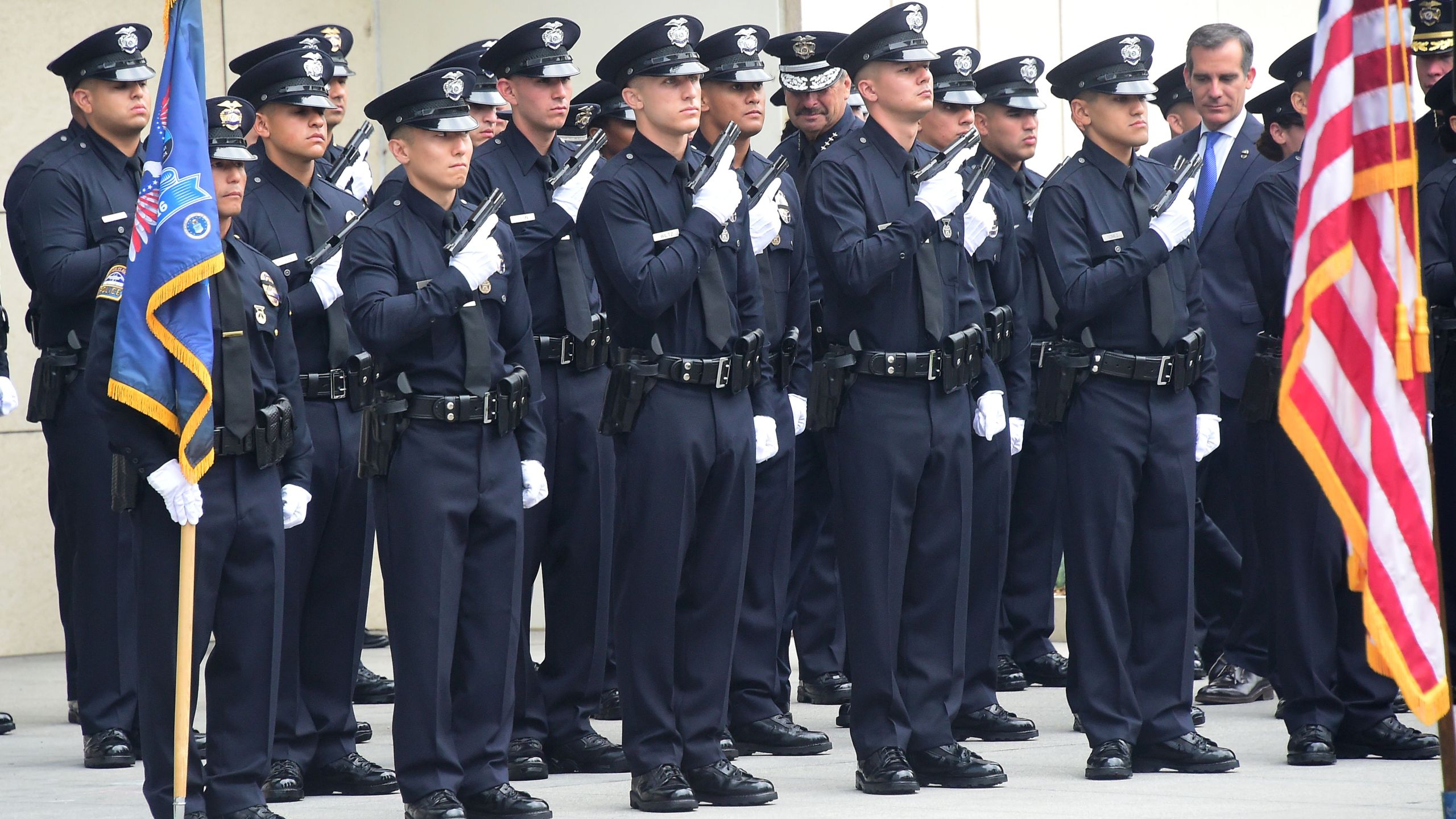 Los Angeles police chief Charlie Beck and mayor Eric Garcetti inspect new Police recruits on July 8, 2016, in Los Angeles. (Credit: Frederic J. Brown/AFP/Getty Images)