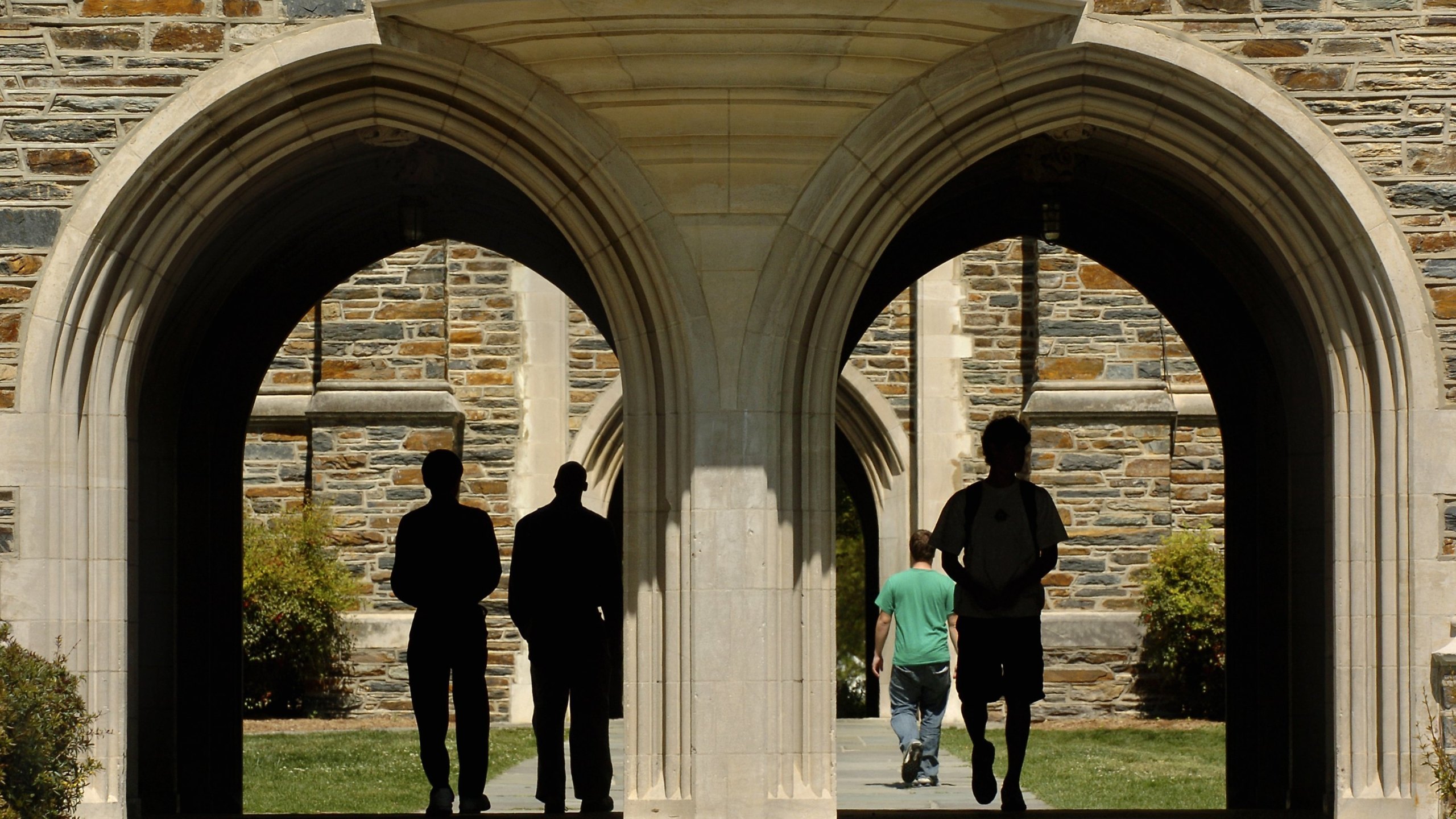 Students pass under the arches at Duke University Tuesday, April 11, 2006 in Durham, North Carolina. (Credit: Sara D. Davis/Getty Images)