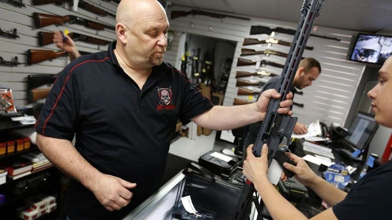 Terry McGuire, owner of the Get Loaded gun store in Grand Terrace in San Bernardino County, shows a customer a Cobalt Kinetics BAMF rifle in this undated photo. (Credit: Barbara Davidson / Los Angeles Times)