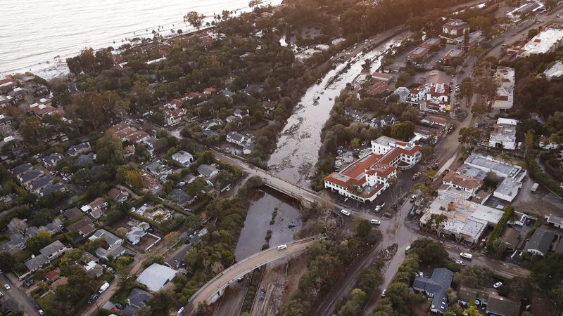 In January 2018, mud and debris clog up the 101 Freeway at the Olive Mill Road overpass in Montecito, after an onslaught of deadly mudslides. (Credit: Al Seib / Los Angeles Times)