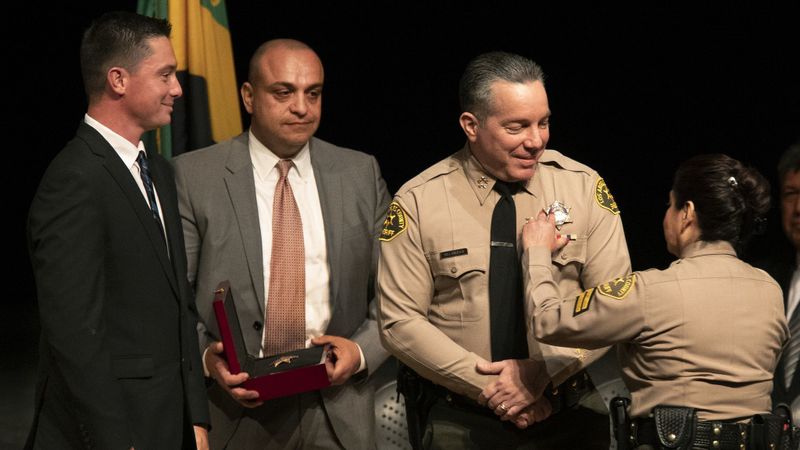 Caren Carl Mandoyan, second from left, looks on during L.A. County Sheriff Alex Villanueva's swearing-in ceremony in December 2018. (Mel Melcon / Los Angeles Times)