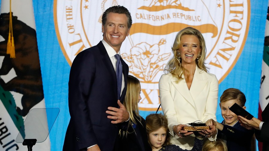 Gavin Newsom is sworn in as governor of California by California Chief Justice Tani Gorre Cantil-Sakauye as Newsom's wife, Jennifer Siebel Newsom, watches on Jan. 7, 2019, in Sacramento. (Credit: Stephen Lam/Getty Images)