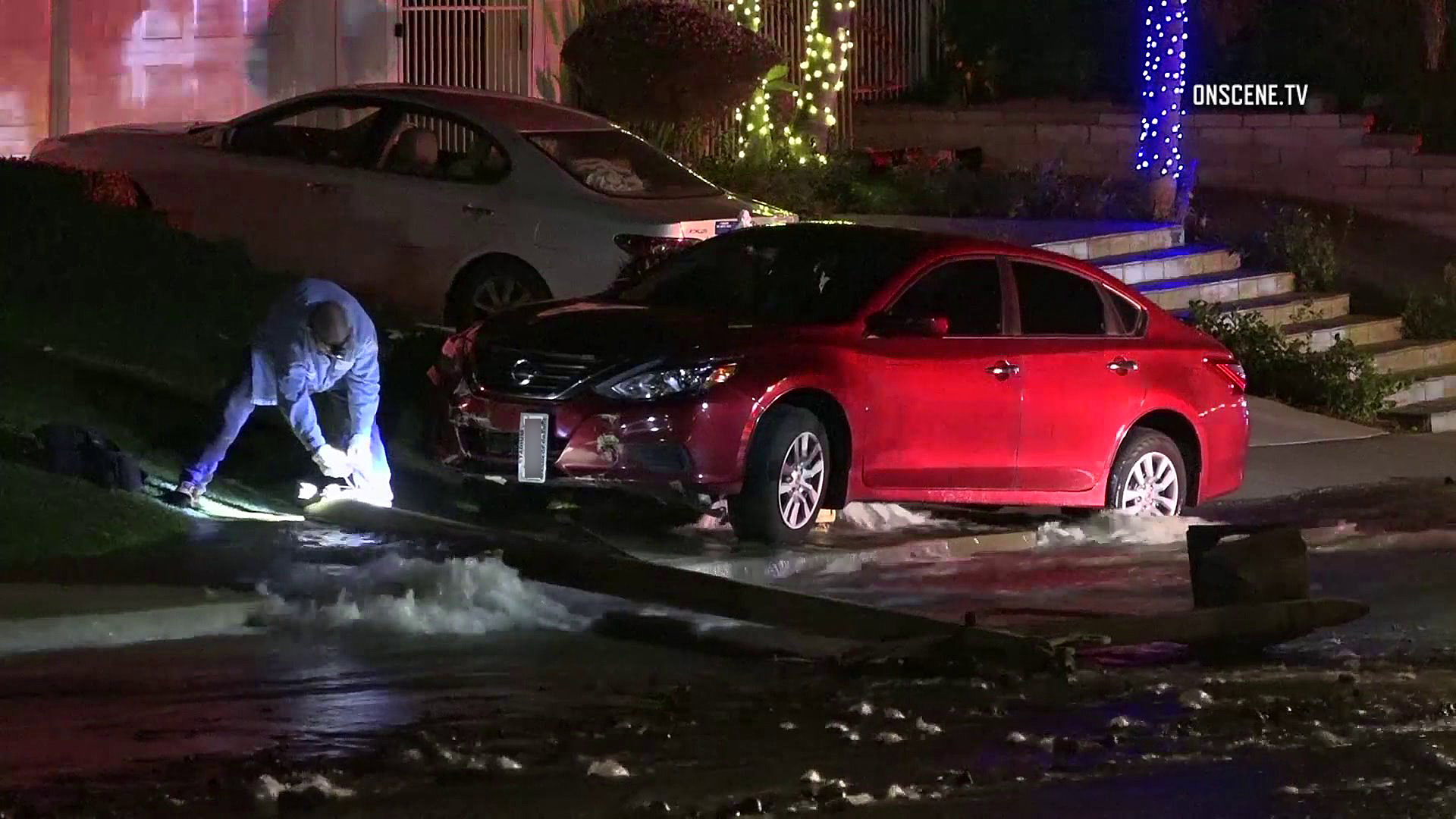 Water streams into the street after a car crashed into a hydrant in Anaheim on Jan. 2, 2019. (Credit: OnScene.TV)