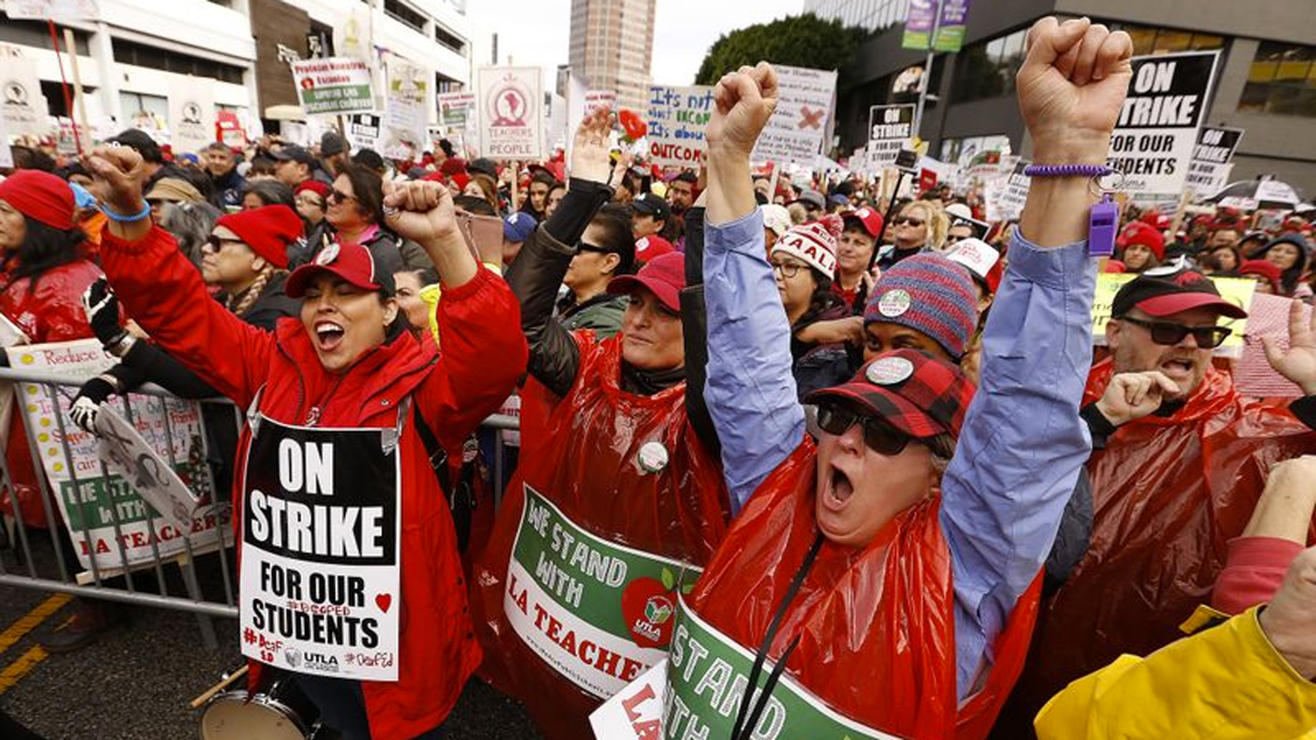 Janette Duran, from left, Lauren Maucere and Stephanie Johnson, all specialists at Marlton School for the deaf, cheer at a rally at the California Charter Schools Assn. in downtown Los Angeles. (Credit: Al Seib / Los Angeles Times)