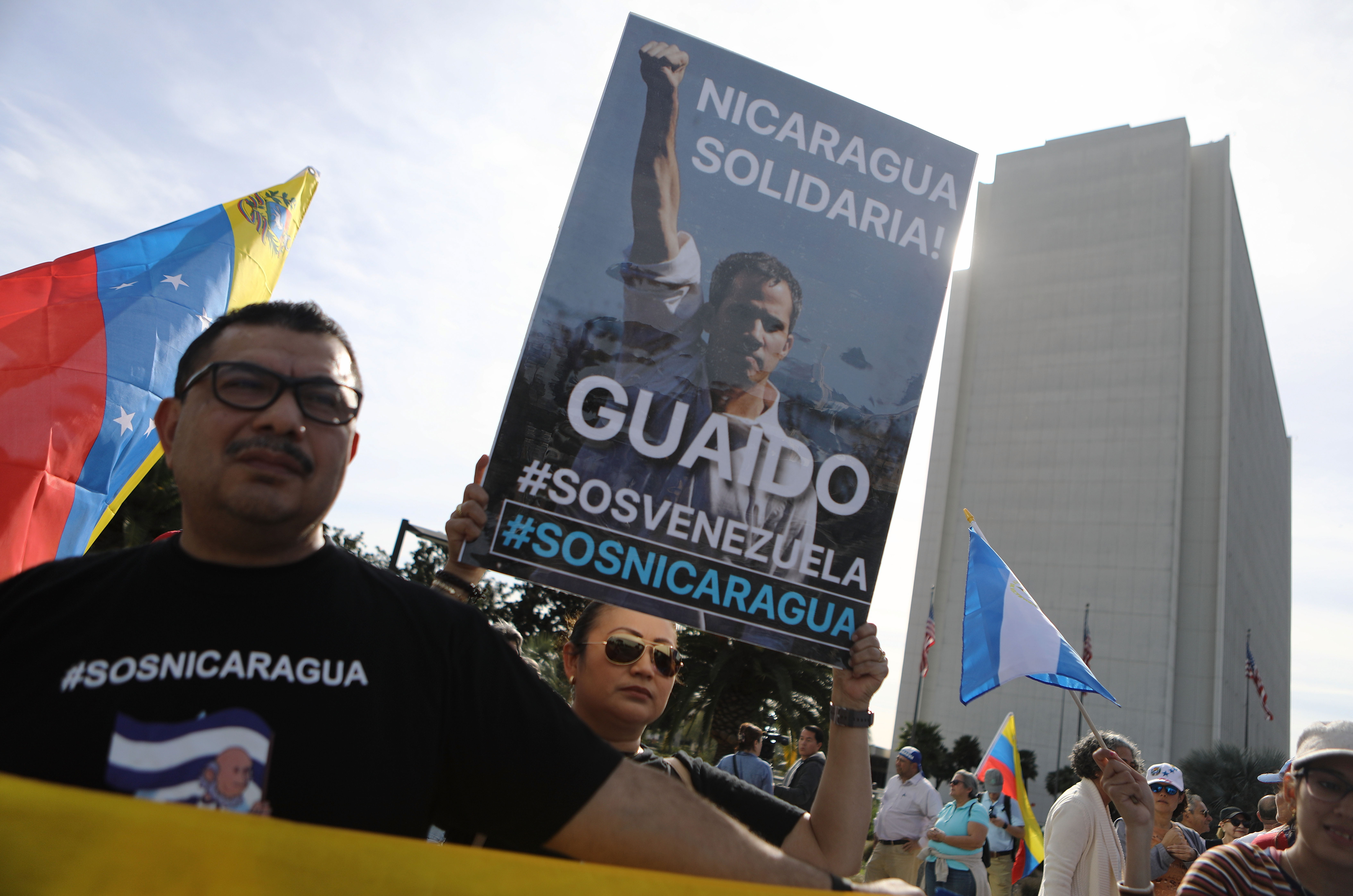 Anti-Maduro demonstrators gather as one holds a poster of Venezuelan opposition leader Juan Guaido, outside the Federal Building, on January 26, 2019 in Los Angeles, California. The protestors called for Guaido to be installed as the head of state of Venezuela. Some Nicaraguan protestors joined the demonstration in solidarity. (Credit: Mario Tama/Getty Images)