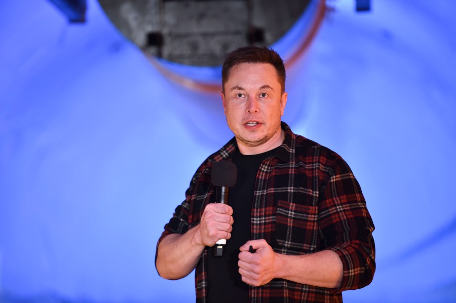 Elon Musk, co-founder and CEO of Tesla, speaks at an unveiling event for The Boring Co.'s test tunnel in Hawthorne on Dec. 18, 2018. (Credit: Robyn Beck / Getty Images)