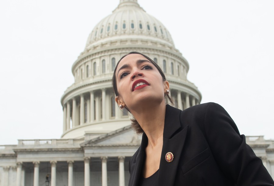 Representative Alexandria Ocasio-Cortez, Democrat of New York, leaves a photo opportunity with the female Democratic members of the 116th U.S. House of Representatives outside the U.S. Capitol on Jan. 4, 2019. (Credit: Saul Loeb/AFP/Getty Images)