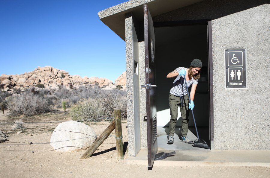 Volunteer Alexandra Degen cleans a restroom at Joshua Tree National Park on January 4, 2019 in Joshua Tree National Park, California. (Credit: Mario Tama/Getty Images)