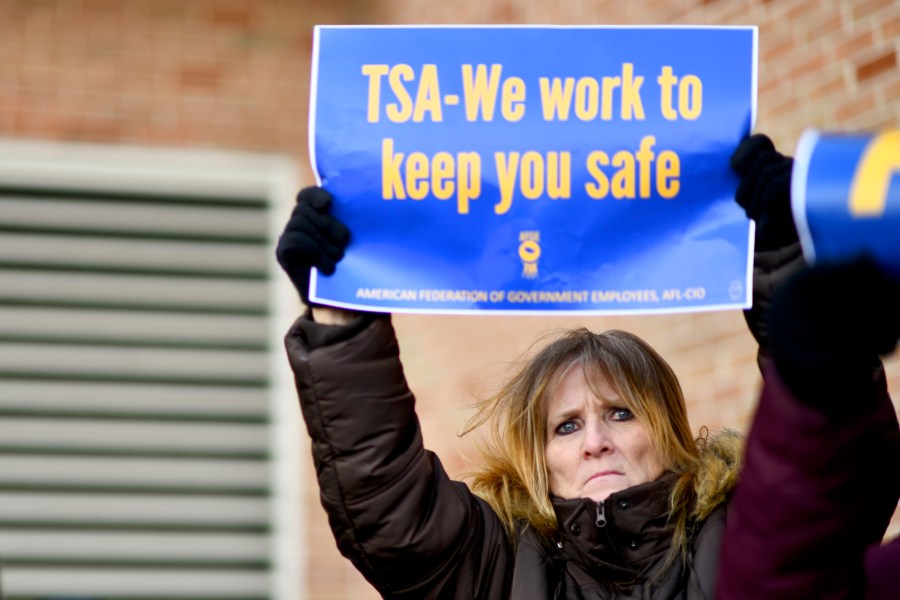 Elizabeth Hughes holds a placard stating "TSA- We work to keep you safe" while demonstrating with Philadelphia Airport TSA and airport workers outside the Philadelphia International Airport on January 25, 2019 in Philadelphia, Pennsylvania. (Credit: Mark Makela/Getty Images)