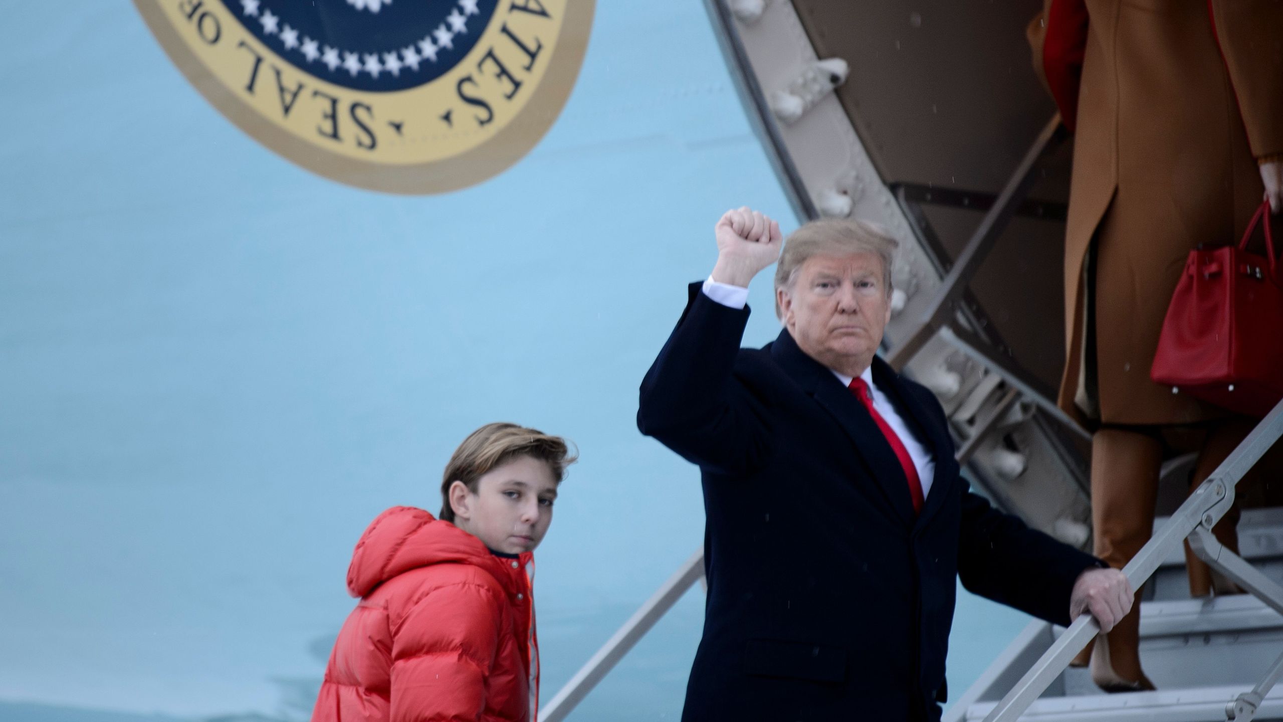 US President Donald Trump and son Barron Trump board Air Force One at Andrews Air Force Base on Feb. 1, 2019, in Maryland, en route to Palm Beach, Fla. (Credit: Brendan Smialowski/AFP/Getty Images)