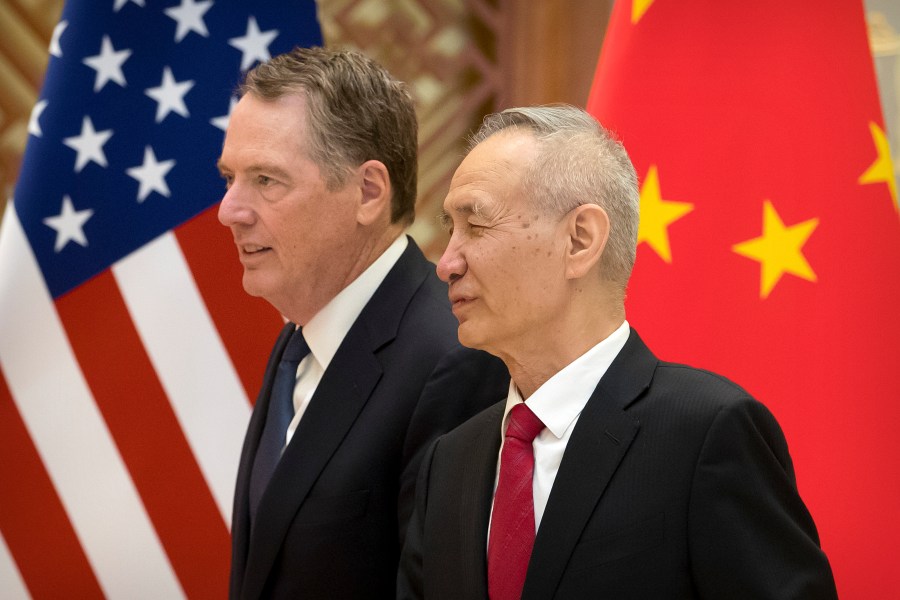 US Trade Representative Robert Lighthizer (L) listens as Chinese Vice Premier Liu He talks while they line up for a group photo at the Diaoyutai State Guesthouse in Beijing on February 15, 2019. (Credit: MARK SCHIEFELBEIN/AFP/Getty Images)