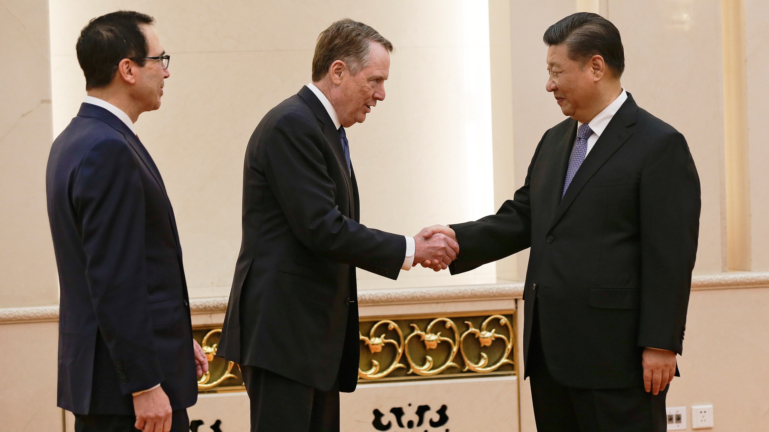 US Trade Representative Robert Lighthizer (C) shakes hands with Chinese President Xi Jinping next to US Treasury Secretary Steven Mnuchin (L) before proceeding to their meeting at the Great Hall of the People in Beijing on February 15, 2019. (Credit: ANDY WONG/AFP/Getty Images)